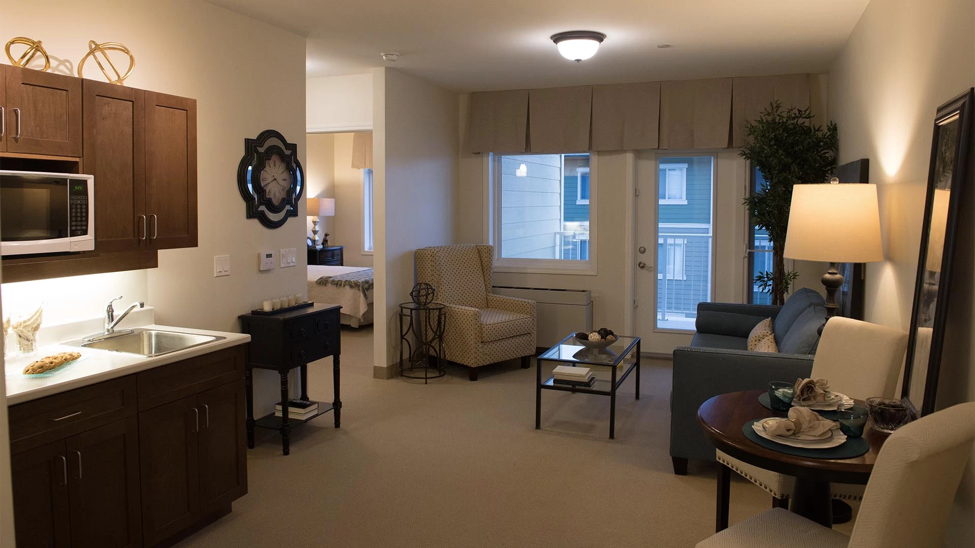 A kitchenette and living room view in an Everitt Gardens suite