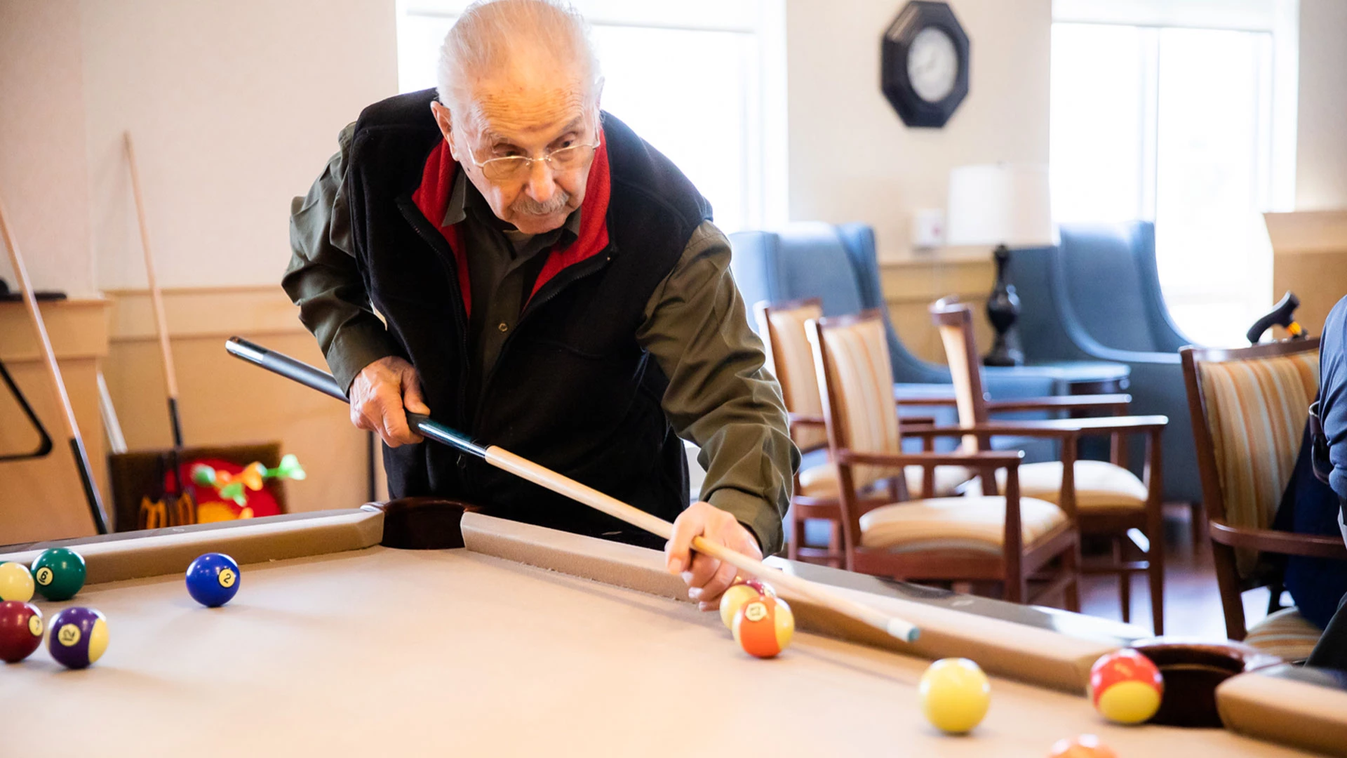 Senior playing pool