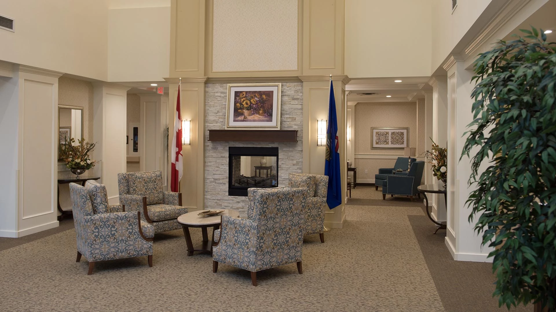Arm chairs and a fireplace in the lobby of Everitt Gardens in St. Albert