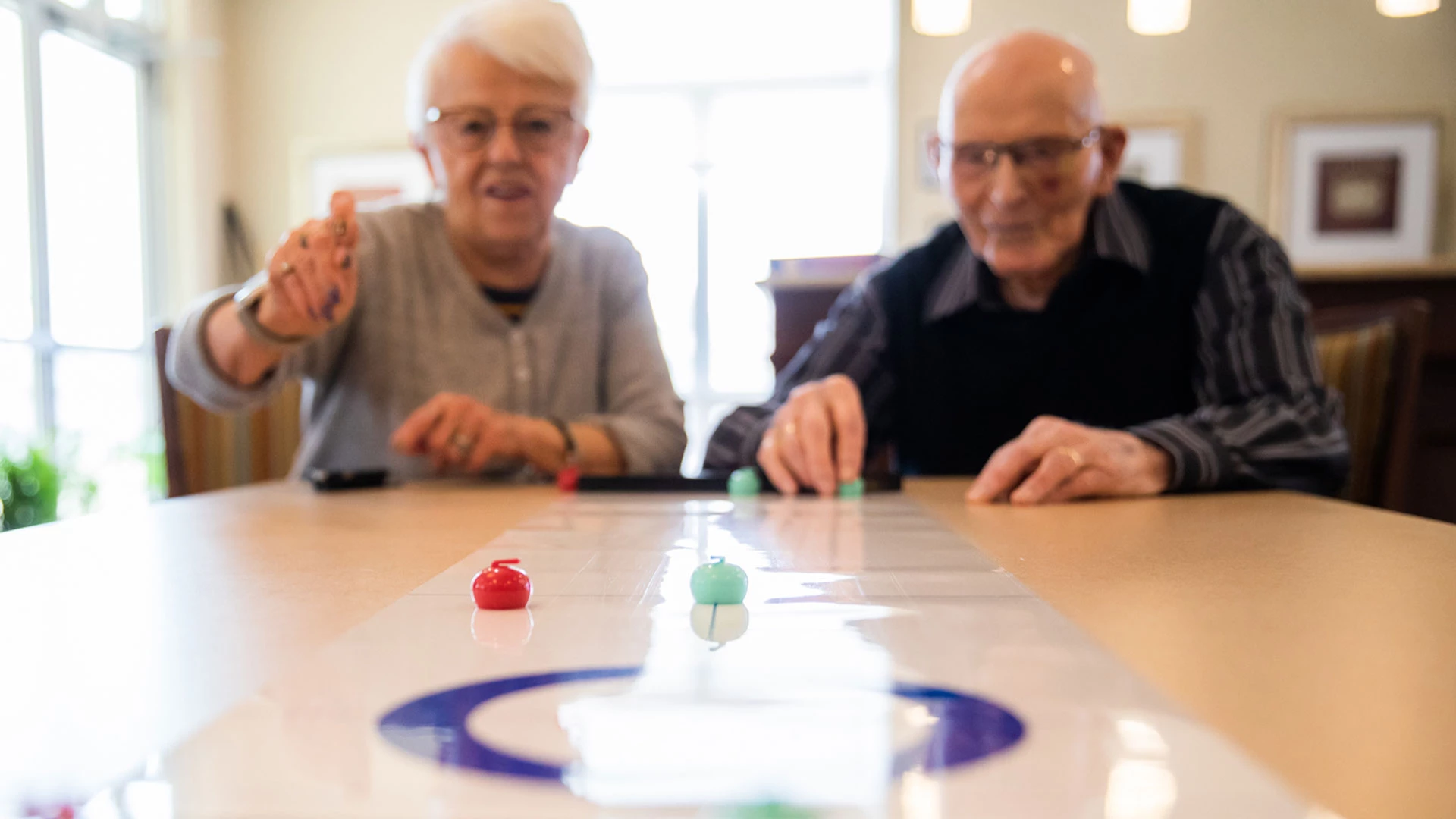 Two seniors playing a game together